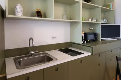 a kitchen with a sink and a microwave at Romantic Suite nel Cuore di Roma - Piazza Navona - in Rome