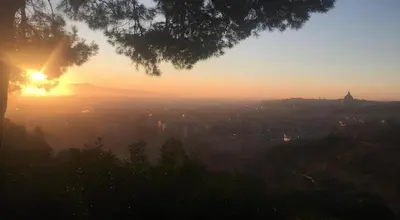 a view of the sun setting over a city at Rifugio Belsito in Rome