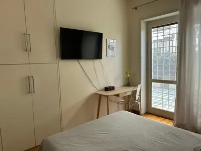 a bedroom with a bed and a television on the wall at Rifugio Belsito in Rome