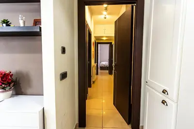 a hallway leading to a room with a hallway at Naos C&G Hospitium in Rome
