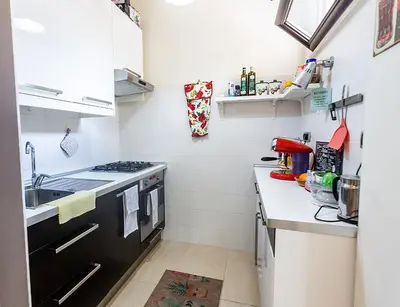 a small kitchen with a sink and a stove at Naos C&G Hospitium in Rome