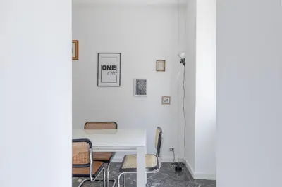 a room with a white table and chairs at iFlat Colosseum Modern & Peaceful Design Apt in Rome
