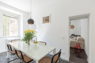 a white dining room with a white table and chairs at iFlat Colosseum Modern & Peaceful Design Apt in Rome