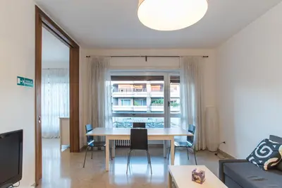 a living room with a table and a couch at House in the City in Rome