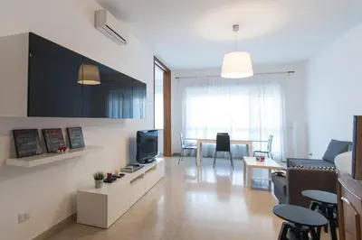 a living room with a couch and a tv and a table at House in the City in Rome