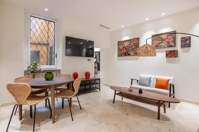 a living room with a table and chairs and a couch at Charming 3 Bedroom Apartment in the Historic Center in Rome