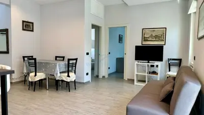 a living room with a table and chairs and a couch at Contemporary Comfort Stylish Modern Apartment in Rome