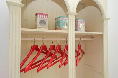 a closet with red utensils on a shelf at Eroi Spacious Apartment in Rome