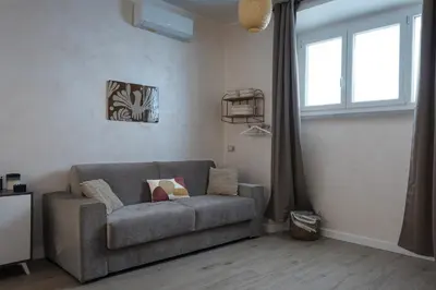 a living room with a couch and a window at 2passi dal Colosseo in Rome