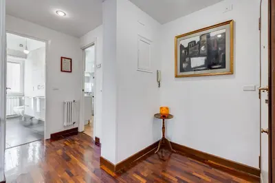 an empty hallway with white walls and wooden floors at HYRIA Holiday Home in Rome