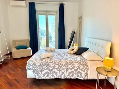a bed with a stuffed animal on top of it at Marconi Living in Rome