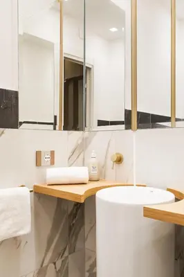a bathroom with a white sink and mirrors at Spanish Steps Modern Gem in Rome