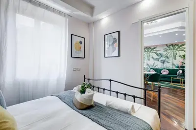 a bedroom with a bed and a living room at Koma 7 Apartment in Rome