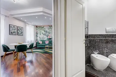 a bathroom with a tub and a table and chairs at Koma 7 Apartment in Rome