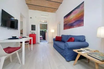 a living room with a blue couch and a table at Colosseo Mon Amour in Rome