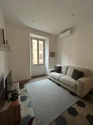 a living room with a couch and a window at Appartamento Ostiense CasaFrai in Rome