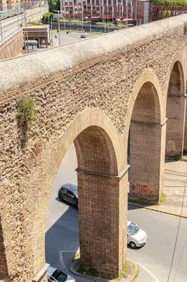 a brick bridge with arches on a city street at Porta Maggiore Cozy Apartment in Rome