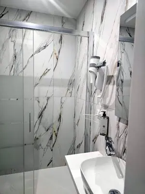a bathroom with a shower and a sink at Aris Square Rome in Rome