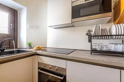 a kitchen with a sink and a counter top at iFlat Campo dei Fiori View and SPA in Rome