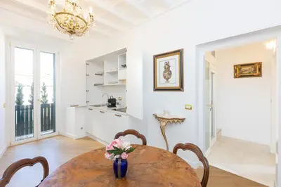 a dining room with a table and a vase with flowers at Amazing Domus Ruspoli in Rome
