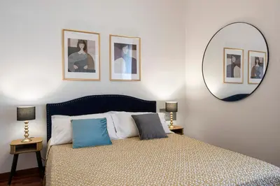 a bedroom with a bed with a mirror on the wall at Boschetto Boutique Apartment in Rome