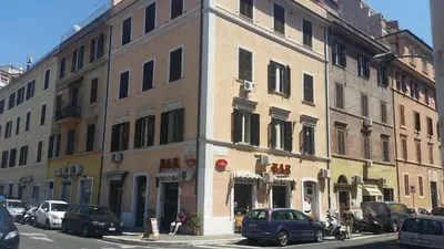 a building on a city street with cars parked outside at Castel Bolognese in Rome