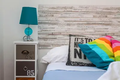 a bedroom with a bed with a wooden accent wall at Castel Bolognese in Rome