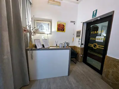 a office with a desk and a door in a room at Check in Rome in Rome
