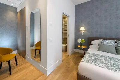 a hotel room with a bed and a mirror at PO1 Augusto - PO2 Cesare - PO3 Nerone in Rome