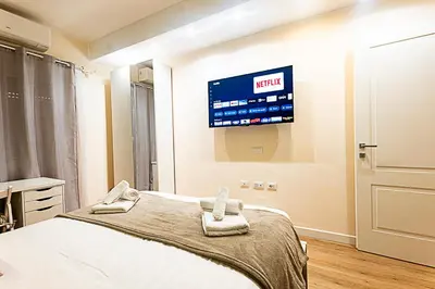 a bedroom with a bed and a tv on the wall at Dave's Home In Trastevere in Rome