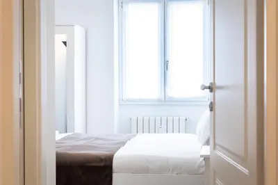 a bedroom with a bed and a window at Amazing Ponte Milvio in Rome