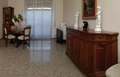 a living room with a wooden cabinet and a table at Al settimo cielo RomaPigneto in Rome