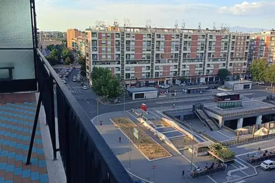 a view of a parking lot with a large building at Al settimo cielo RomaPigneto in Rome