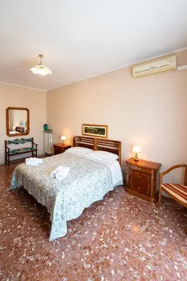 a bedroom with a large bed and two tables at Al settimo cielo RomaPigneto in Rome