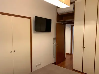 a room with two closets and a television on the wall at Harmony Apartment Via Veneto in Rome