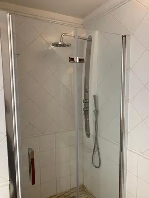 a shower with a shower head in a bathroom at Harmony Apartment Via Veneto in Rome