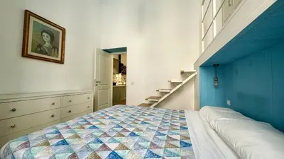 a bedroom with a bed with a quilt on it at Rome Like Home in Rome
