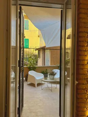 a patio with a white chair and a table at King's Place in Rome