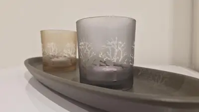 two glass vases sitting on a metal shelf at Eternal City House in Rome