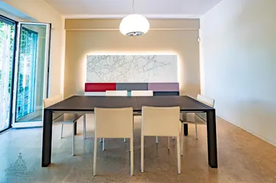 a dining room with a black table and chairs at Domus Consalvi - Ponte Milvio in Rome