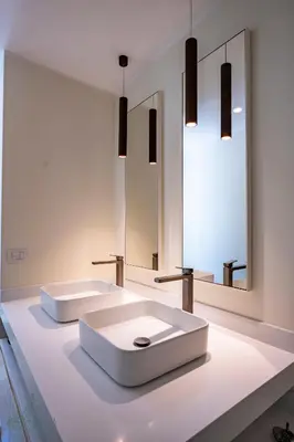 a white bathroom with two sinks and a mirror at Domus Consalvi - Ponte Milvio in Rome