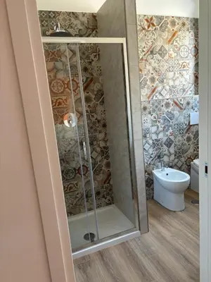 a bathroom with a shower and a toilet at Caos Calmo House in Rome
