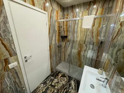 a bathroom with a sink and a shower at Caos Calmo House in Rome