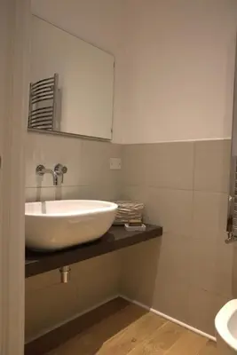 a bathroom with a white sink and a mirror at La Casetta in Rome
