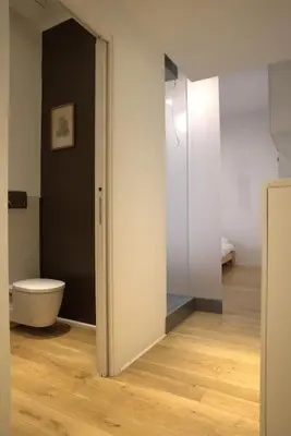 a bathroom with a toilet and a door open at La Casetta in Rome