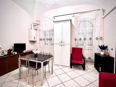 a kitchen with a dining room table and chairs at Rome Is Home in Rome