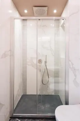 a shower with a glass door in a bathroom at Firenze Boutique Rooms in Rome