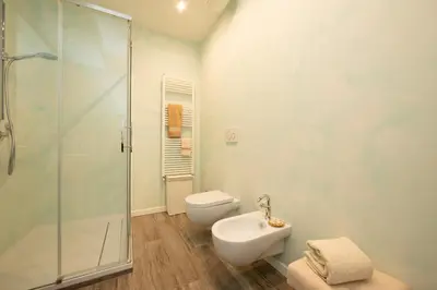a bathroom with a shower and a toilet and a sink at La casa di Ele in Rome