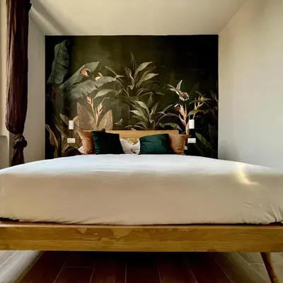 a bedroom with a large bed with a painting on the wall at Elements in Rome