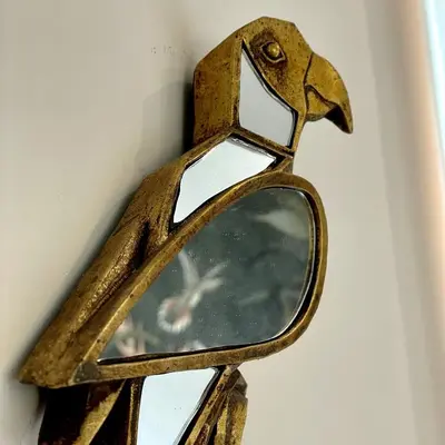 a mirror on a wall with a bird on it at Elements in Rome